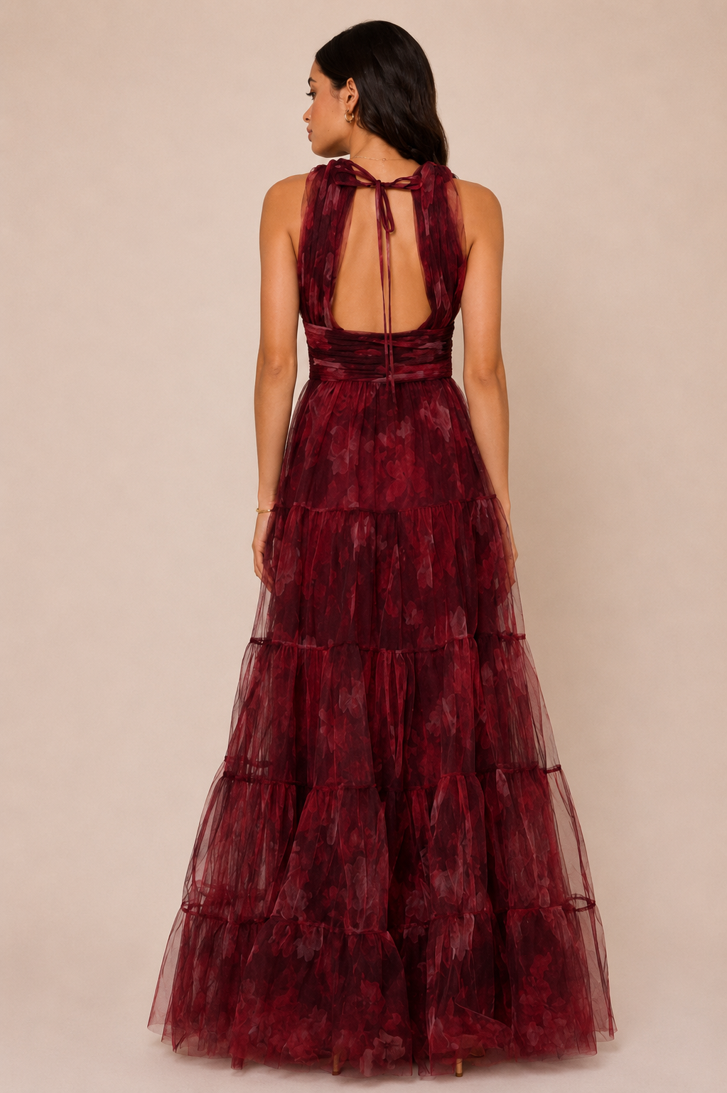 "Burgundy floral tulle tiered maxi dress with plunging halter neckline and open tie-back."
