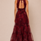 "Burgundy floral tulle tiered maxi dress with plunging halter neckline and open tie-back."

