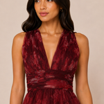 "Burgundy floral tulle tiered maxi dress with plunging halter neckline and open tie-back."
