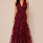 "Burgundy floral tulle tiered maxi dress with plunging halter neckline and open tie-back."
