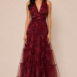 "Burgundy floral tulle tiered maxi dress with plunging halter neckline and open tie-back."
