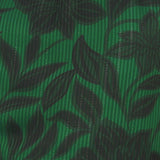 Fabric detail of Flying Tomato Noir Leaf Green Woven Top in green/black