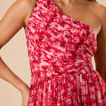 "Raspberry floral chiffon one-shoulder maxi dress with pleated bodice and flowing tie scarf."
