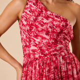 "Raspberry floral chiffon one-shoulder maxi dress with pleated bodice and flowing tie scarf."
