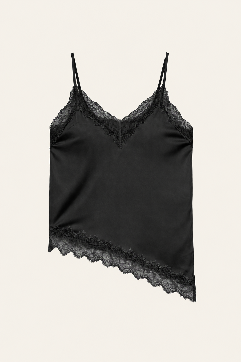 Alexine black satin camisole with floral lace neckline and asymmetric lace hem on an ivory background