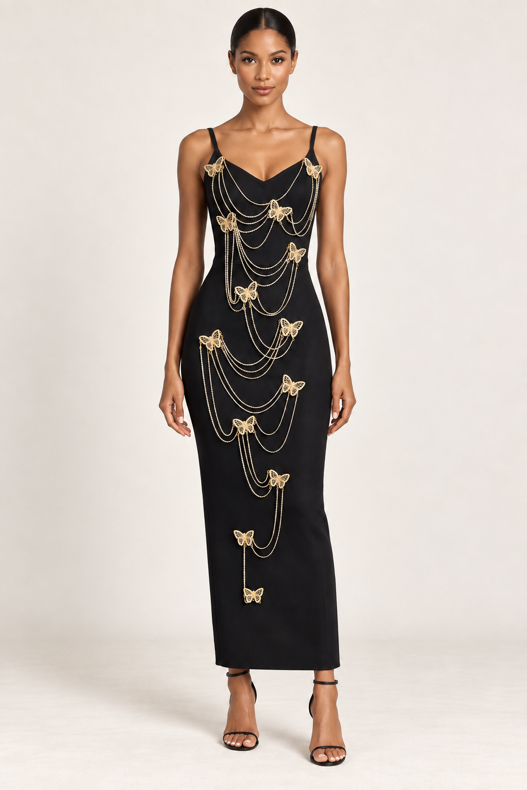 Aurélie black maxi dress with gold butterfly and rhinestone chain embellishments, front view