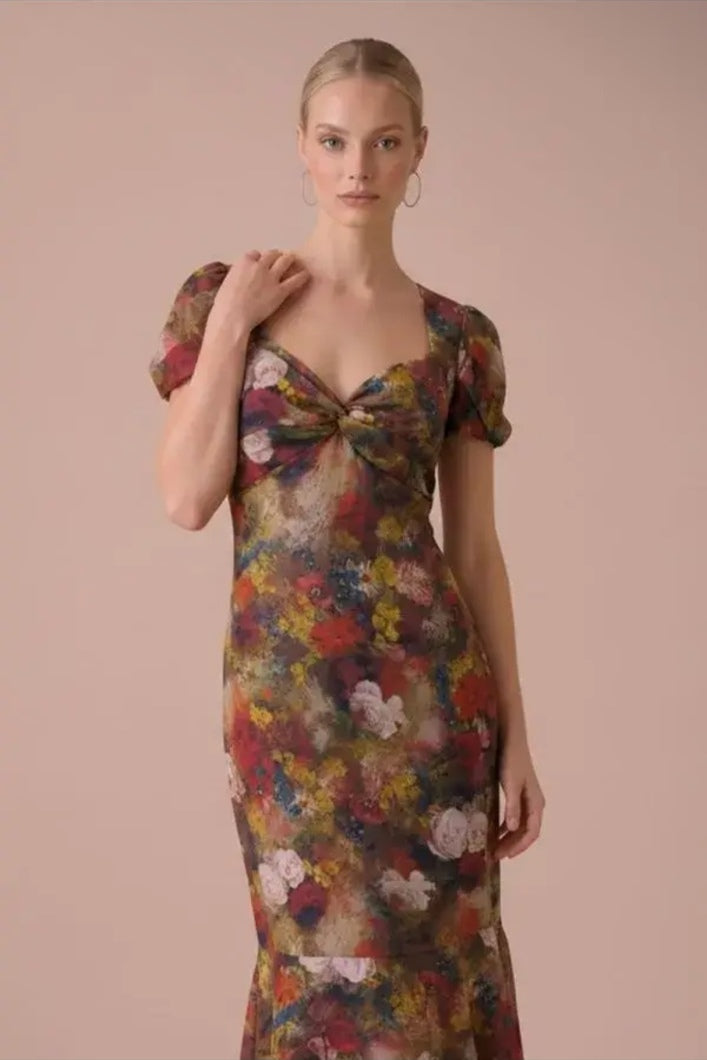 Close-up of the Autumn Muse Floral Twist-Front Midi Dress showing the sweetheart twist bodice, puff sleeves, and autumn floral print