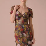 Close-up of the Autumn Muse Floral Twist-Front Midi Dress showing the sweetheart twist bodice, puff sleeves, and autumn floral print