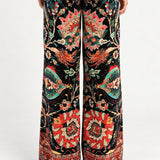 Back view of Aveline Black Aubussy printed velvet wide-leg pants on model