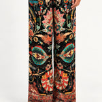 Waist-down front view of Aveline Black Aubussy wide-leg pants and patterned hem