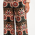 Close-up of the floral print and velvet texture of Aveline Doriala Multi pants