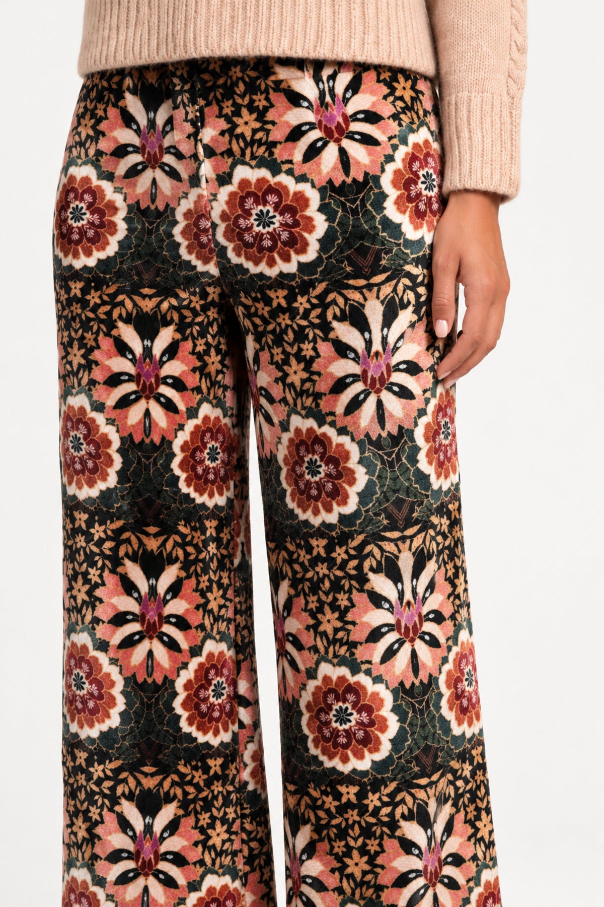 Close-up of the floral print and velvet texture of Aveline Doriala Multi pants