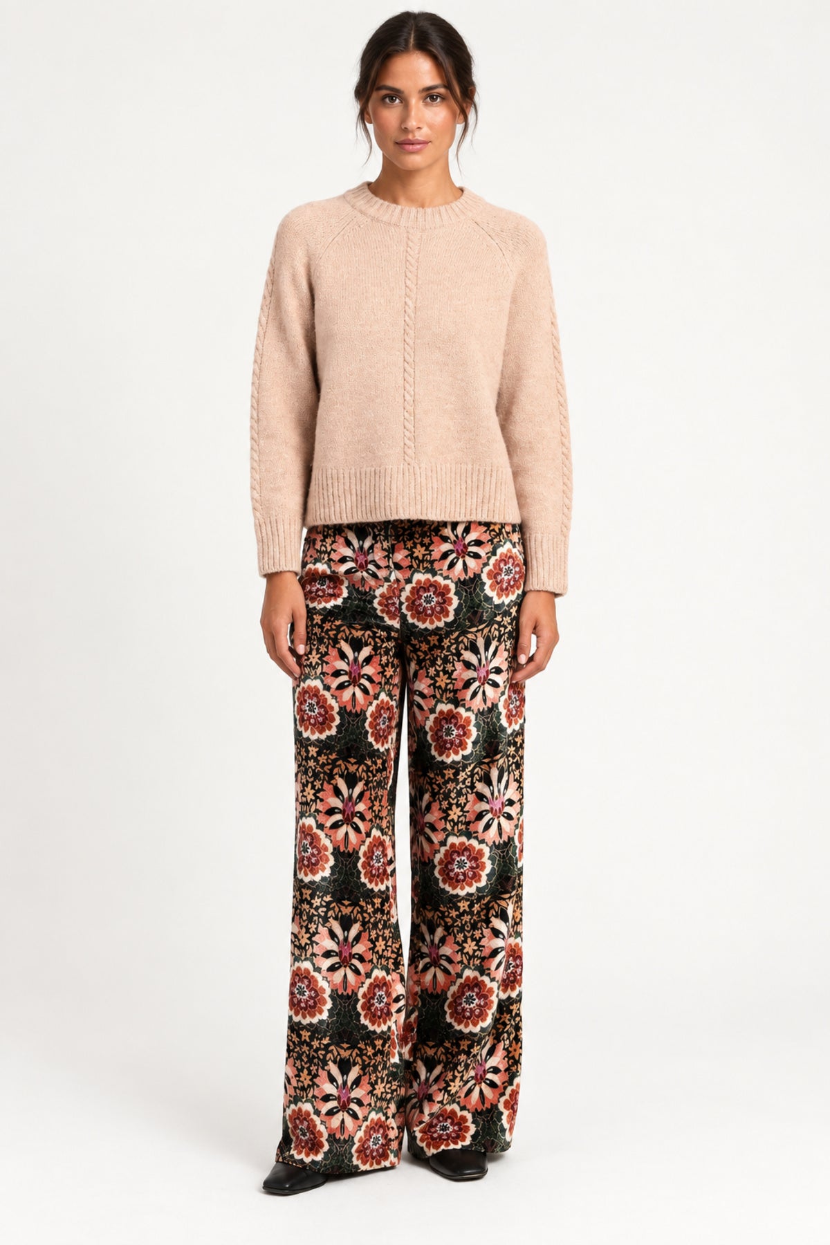 Model wearing Aveline Doriala Multi printed velvet wide-leg pants with a nude sweater, front view