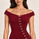 Bordeaux Allure off-shoulder neckline and gold clasp detail, generated close-up