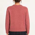 Clémence cable-detail crewneck sweater in Rosewood, back model view on an ivory backdrop