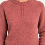 Clémence cable-detail crewneck sweater in Rosewood, close up model view on an ivory backdrop