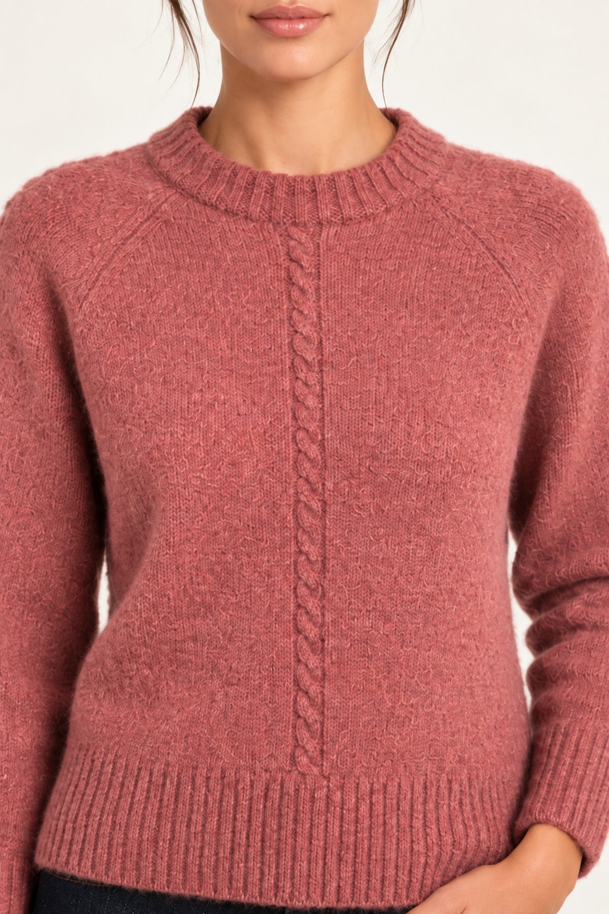 Clémence cable-detail crewneck sweater in Rosewood, close up model view on an ivory backdrop