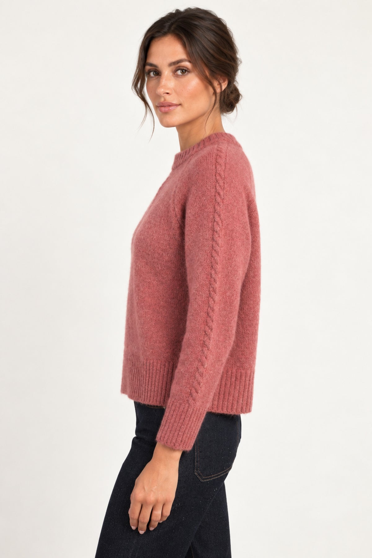 Clémence cable-detail crewneck sweater in Rosewood, side model view on an ivory backdrop