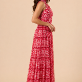 "Raspberry floral chiffon one-shoulder maxi dress with pleated bodice and flowing tie scarf."
