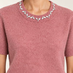 Close-up of the Émeline Rose sweater's jeweled crew neckline, short sleeve and soft knit texture