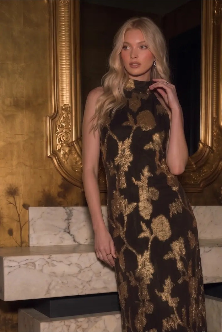 Close-up of the Gilded Bloom Halter Jacquard Dress showing metallic gold floral texture on brown