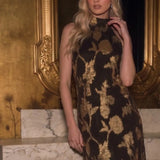Close-up of the Gilded Bloom Halter Jacquard Dress showing metallic gold floral texture on brown