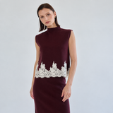 Sleeveless mock-neck burgundy knit top with ivory scalloped floral lace