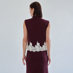 Back of burgundy knit top showing ivory lace hem