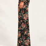 Side view of Héloïse Jacquard Wide-Leg Pants in Black Floral, showing the full-length flared cut