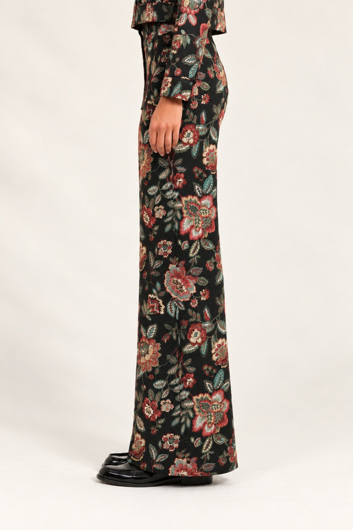 Side view of Héloïse Jacquard Wide-Leg Pants in Black Floral, showing the full-length flared cut
