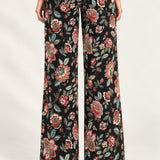 Rear view of Héloïse Jacquard Wide-Leg Pants in Black Floral against an ivory background