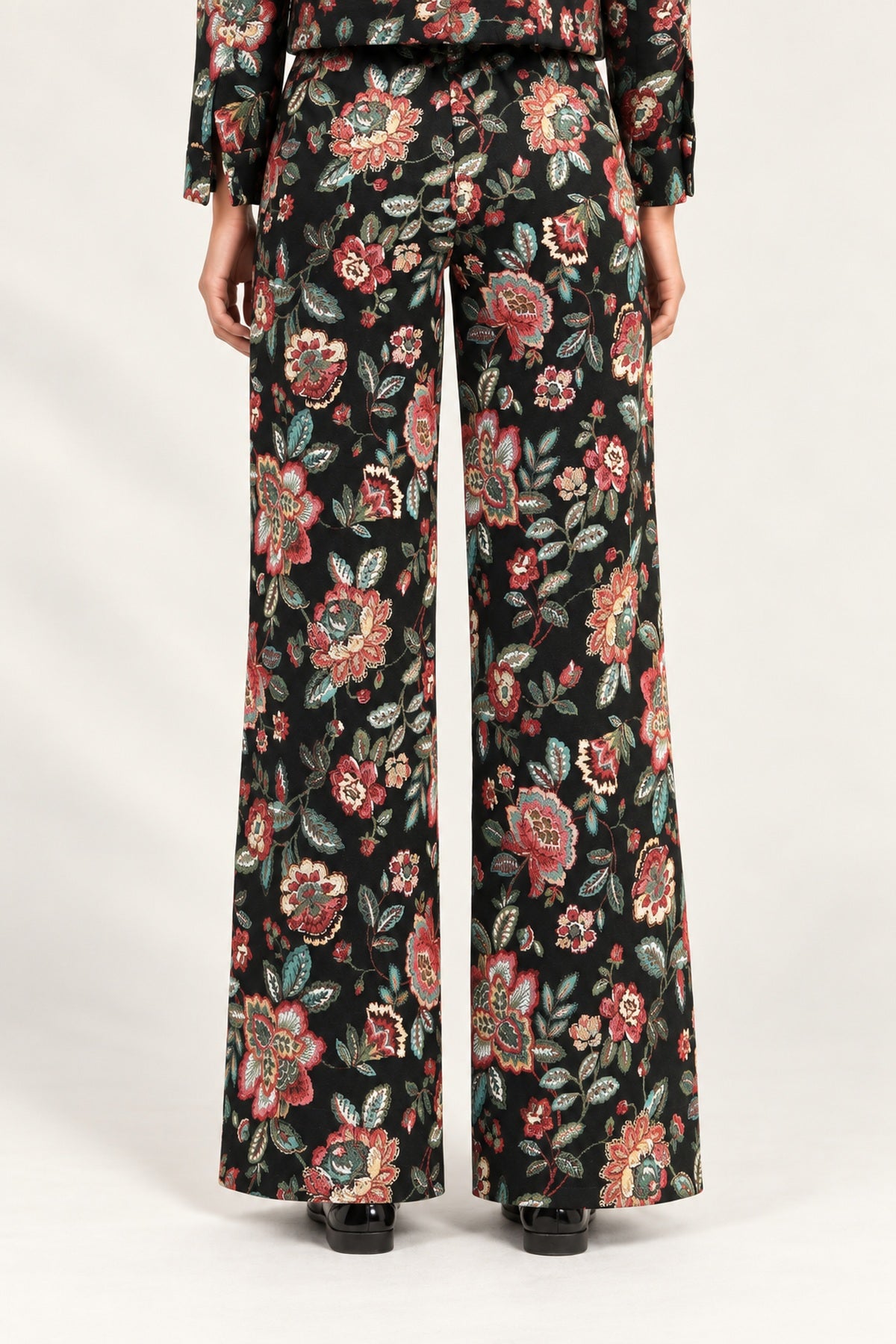 Rear view of Héloïse Jacquard Wide-Leg Pants in Black Floral against an ivory background