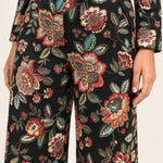 Close-up of the Héloïse Black Floral pants waistband, button and woven botanical jacquard
