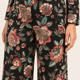 Close-up of the Héloïse Black Floral pants waistband, button and woven botanical jacquard