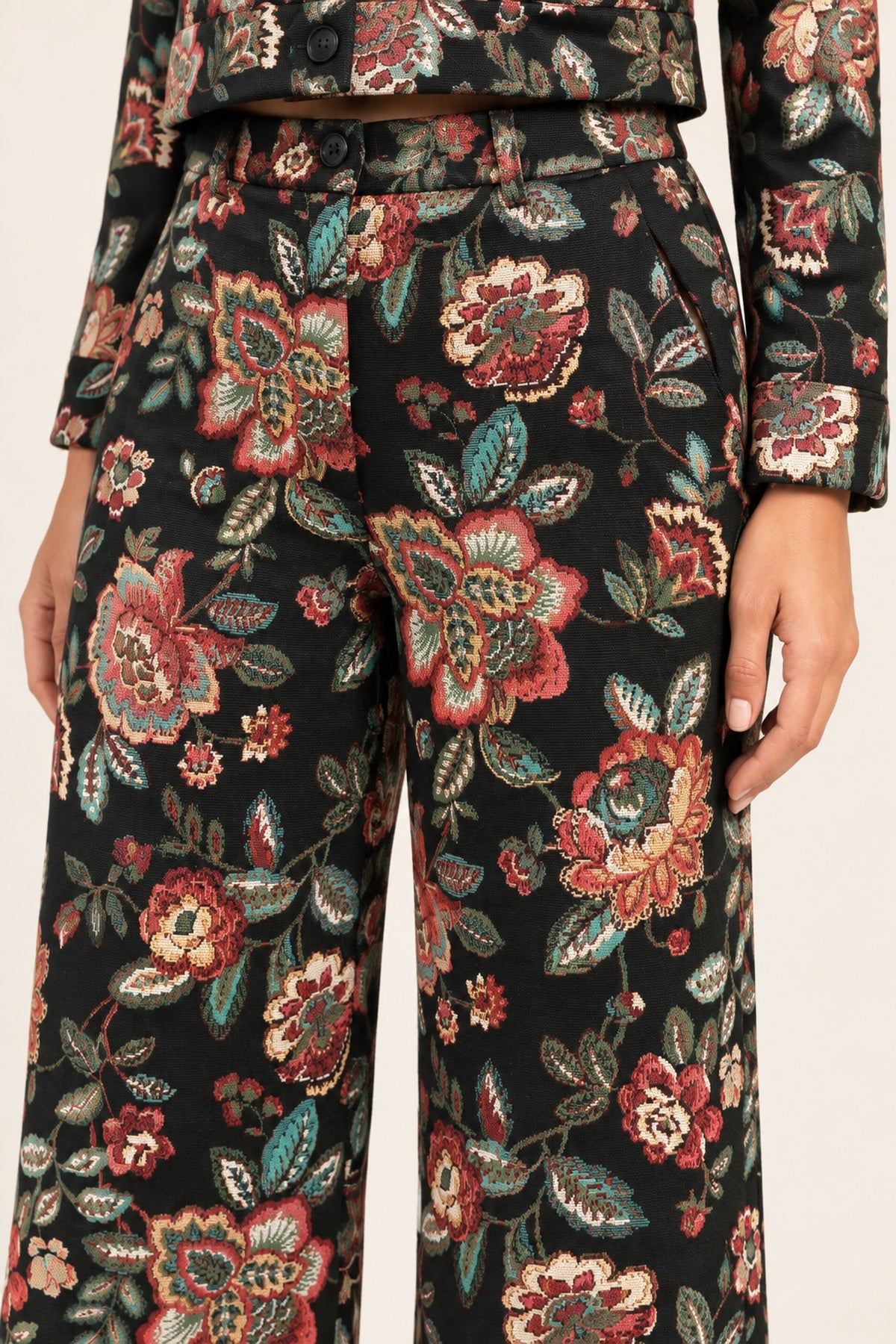 Close-up of the Héloïse Black Floral pants waistband, button and woven botanical jacquard