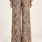 Rear view of Héloïse Jacquard Wide-Leg Pants in Multico Chevron against an ivory background