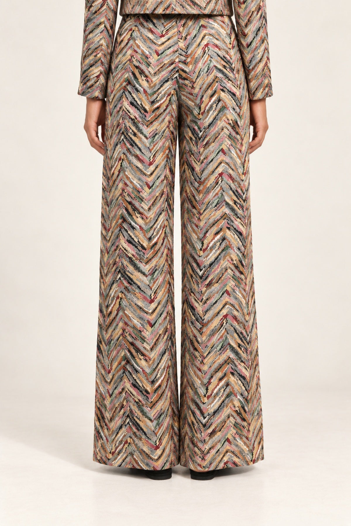 Rear view of Héloïse Jacquard Wide-Leg Pants in Multico Chevron against an ivory background