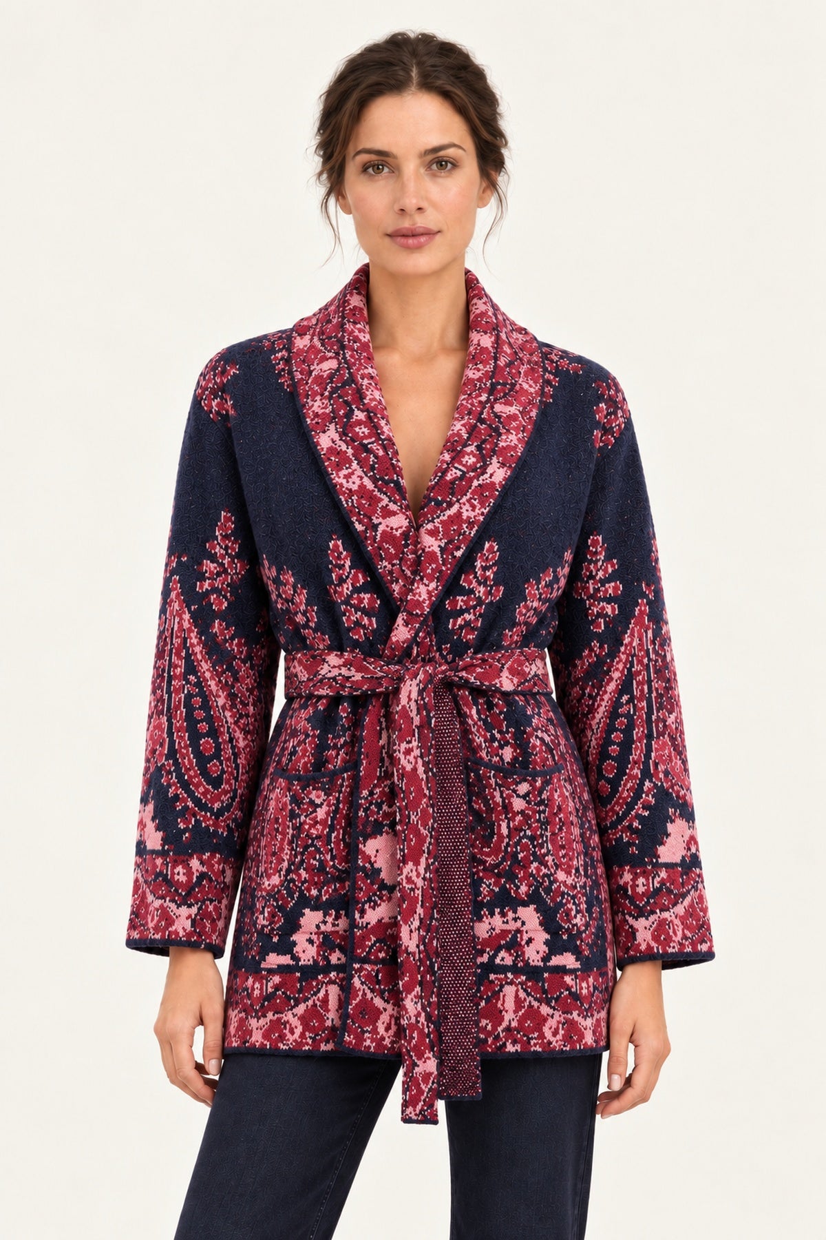Nadège navy paisley jacquard belted cardigan with shawl collar and patch pockets on a model, ivory studio background