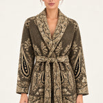 Nadège taupe paisley jacquard belted cardigan with shawl collar and patch pockets on a model, ivory studio background