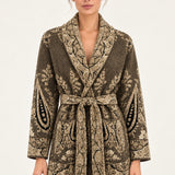 Nadège taupe paisley jacquard belted cardigan with shawl collar and patch pockets on a model, ivory studio background
