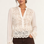 Front view of Georgette Lace Blouse in ecru on model with brown jeans