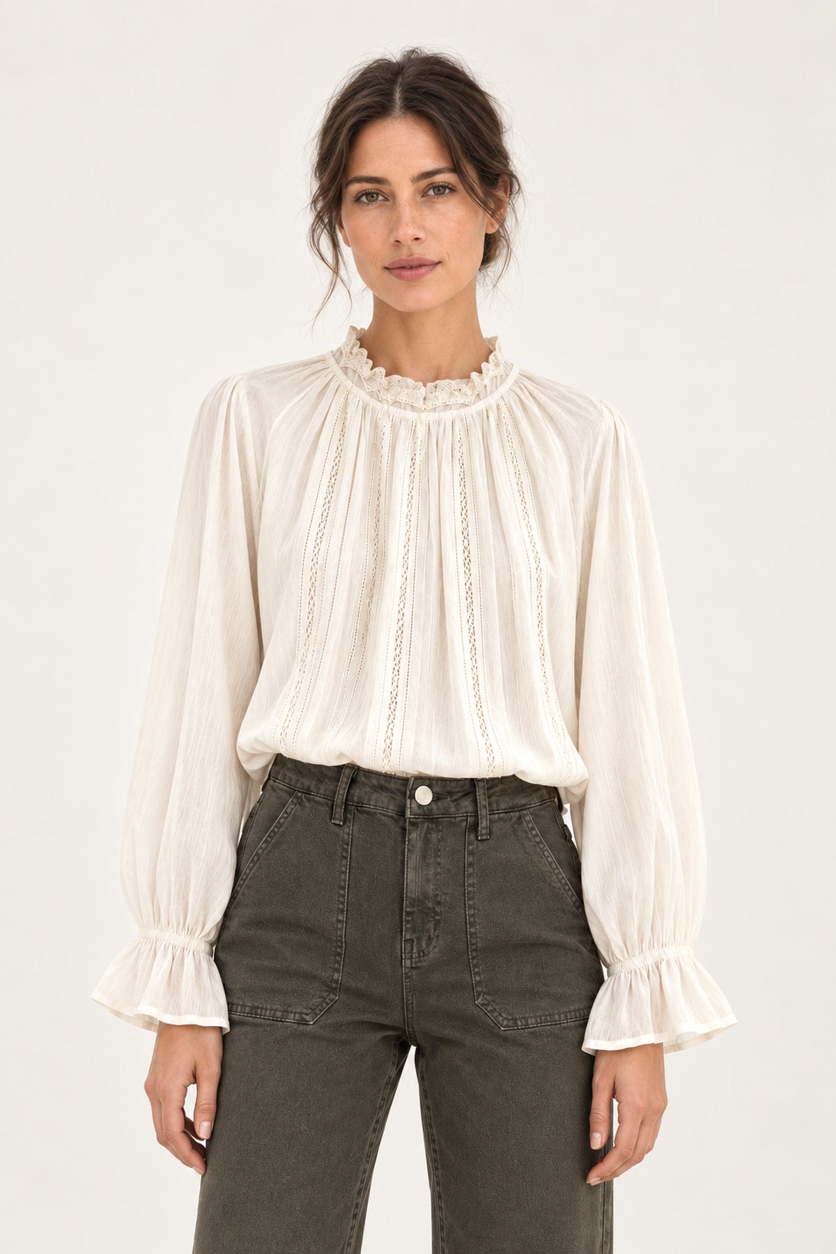 Sabine écru lace-trim blouse, front view showing ruffled collar and fluted cuffs on a model against an ivory background