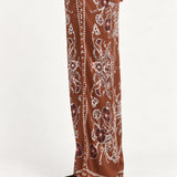 Séverine Passila Chocolate pants, side model view on an ivory studio backdrop