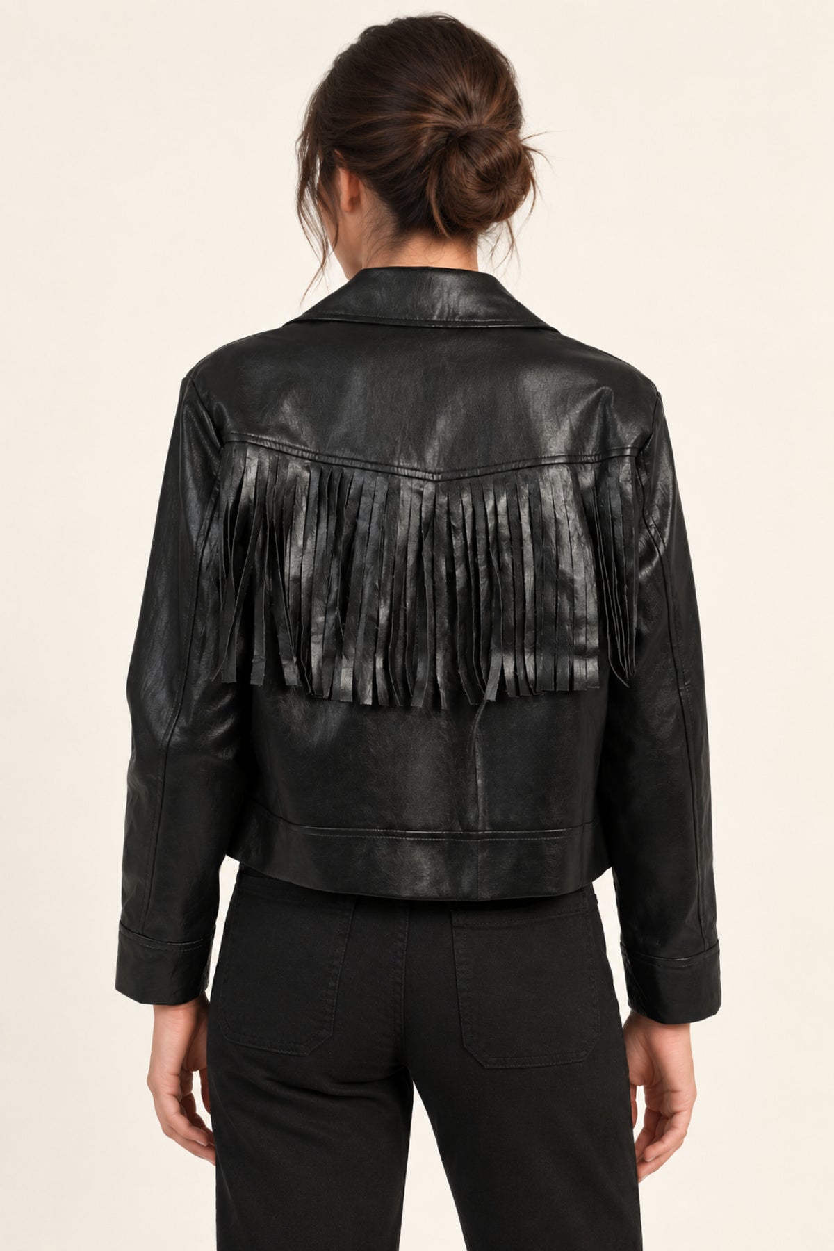 Sidonie fringe faux-leather jacket in Black, back view showing fringe on an ivory studio backdrop