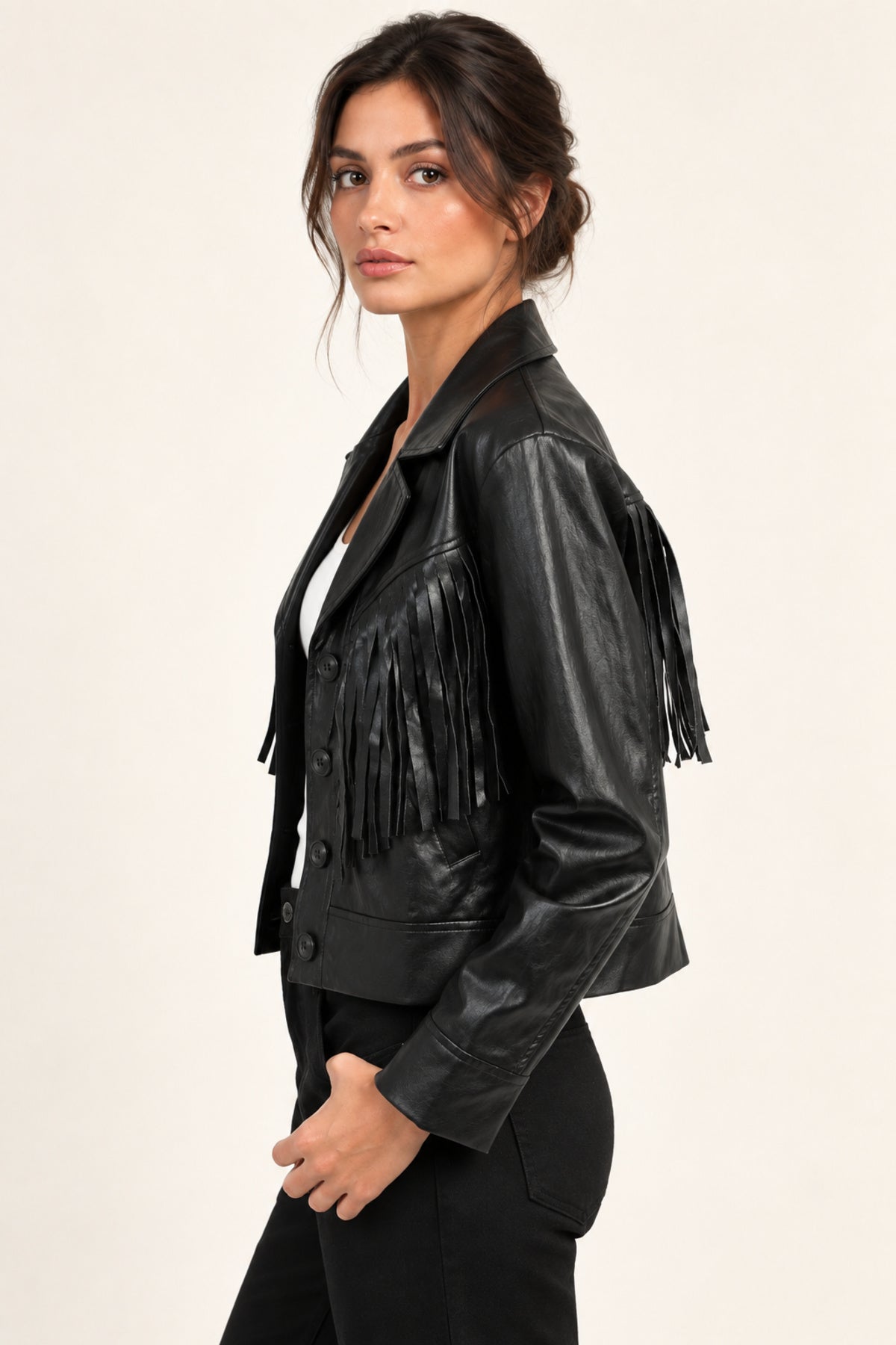 Sidonie fringe faux-leather jacket in Black, side view on an ivory studio backdrop