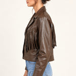 Sidonie fringe faux-leather jacket in Coffee, side view on an ivory studio backdrop