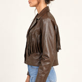 Sidonie fringe faux-leather jacket in Coffee, side view on an ivory studio backdrop