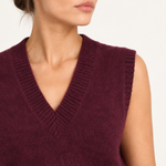 Solène burgundy sweater vest with floral trousers — close-up